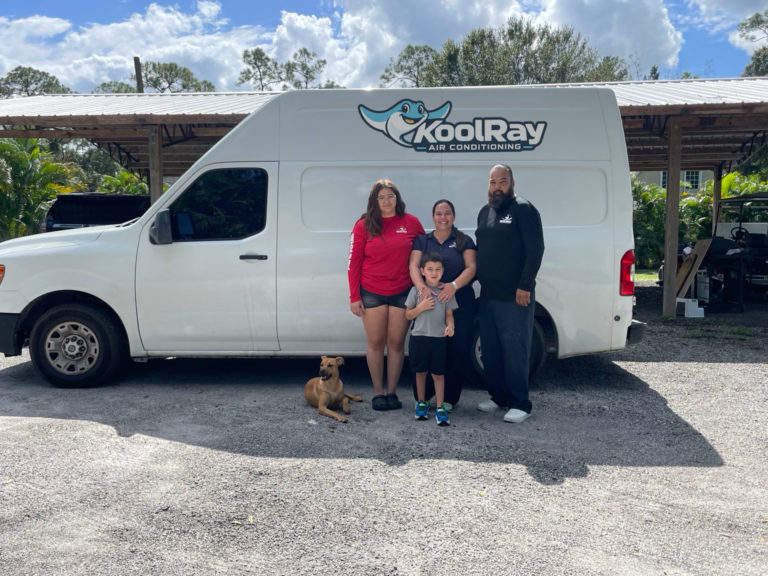 The KoolRay family and dog beside a service van
