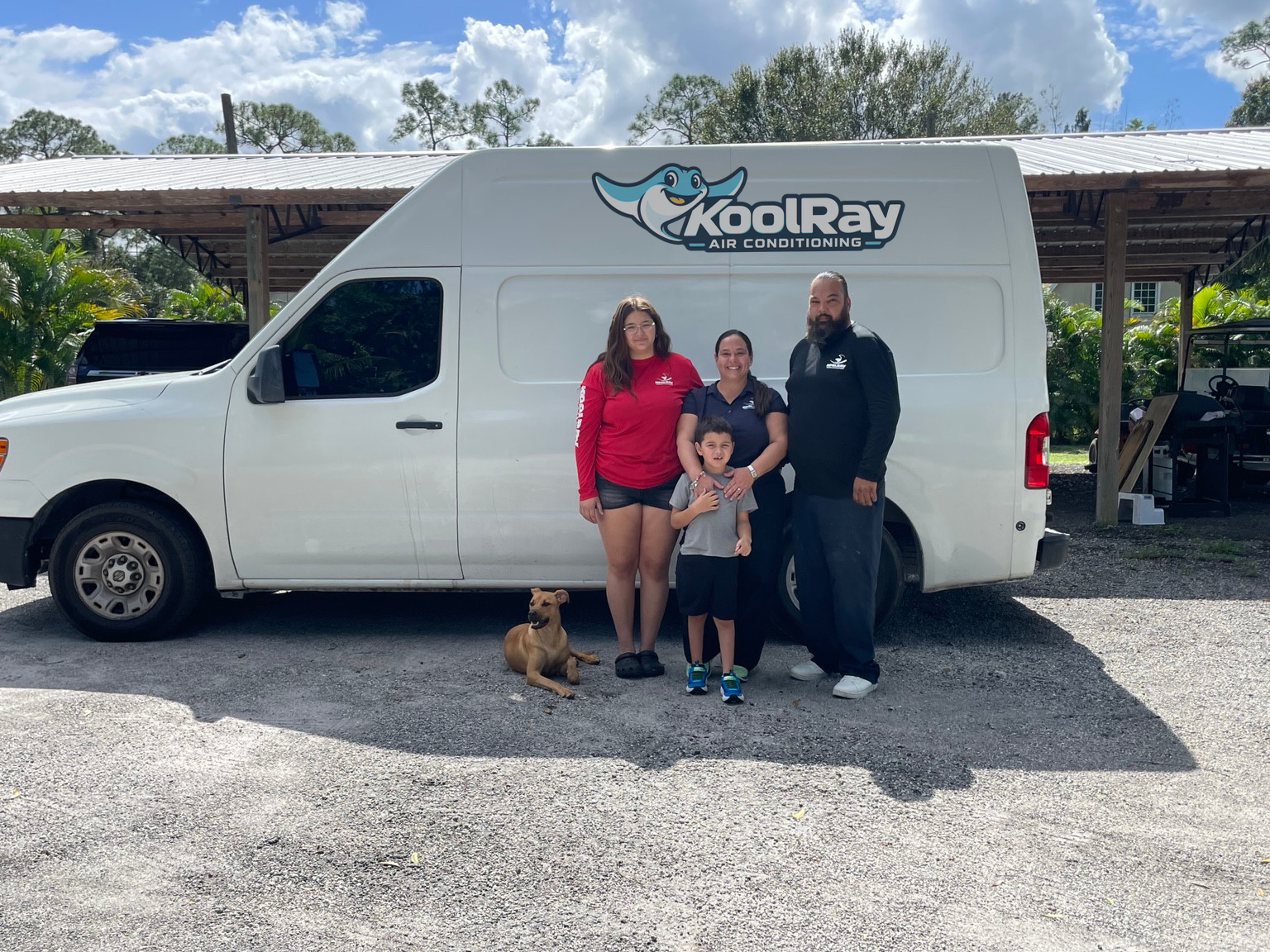 The KoolRay family and dog beside a service van