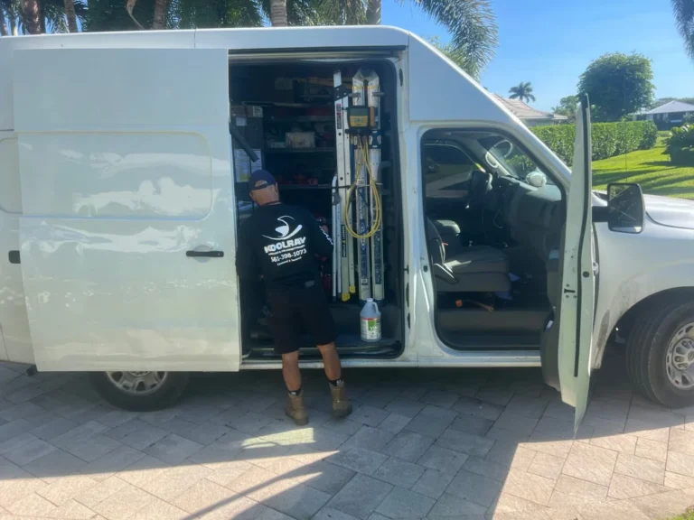 KoolRay technician getting equipment from a service van in a local neighborhood