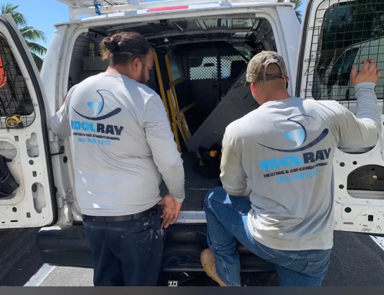 Two people wearing KoolRay shirts beside an open service van